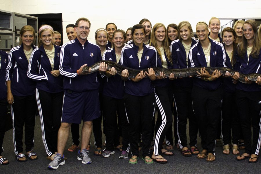 The Bruin women’s soccer team poses with one of Coach Chris Carmichael’s pythons. <em> Photo: Amy Roukes </em> 
