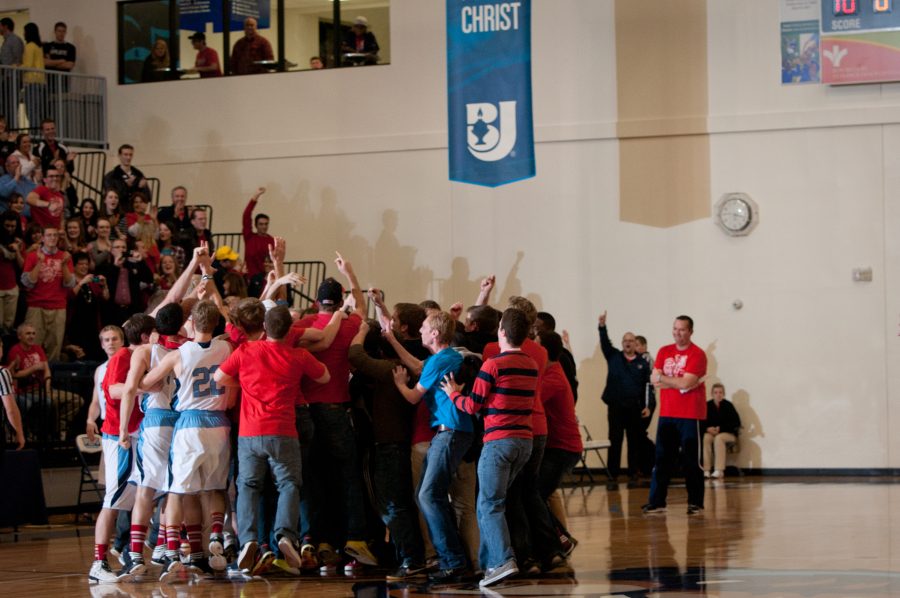 BJU Bruins fans and players celebrate the 86-84 victory after an exhilarating run in post-regulation play.     Photo: Emma Klak 