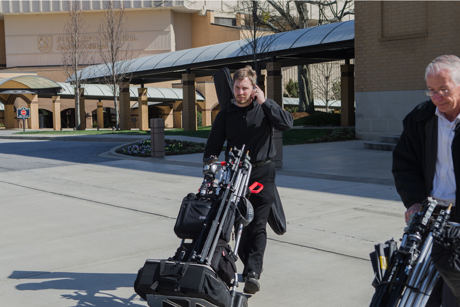 Mr. Hal Cook transports photo equipment across campus for a photo shoot. Photo: Jacob Larsen