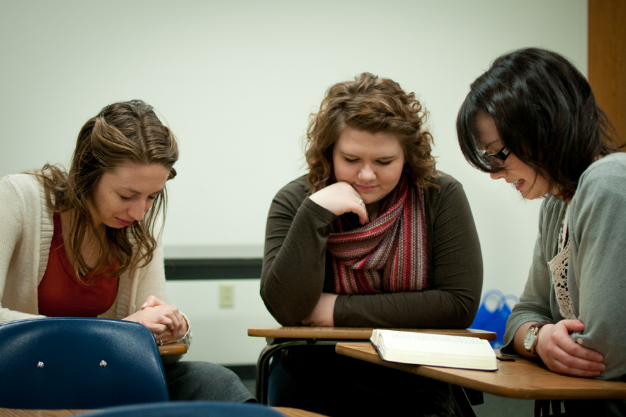 Janelle Claypool, Rebekah McAnally and Catherine Cleland pause for a word of prayer. Photo: Emma Klak