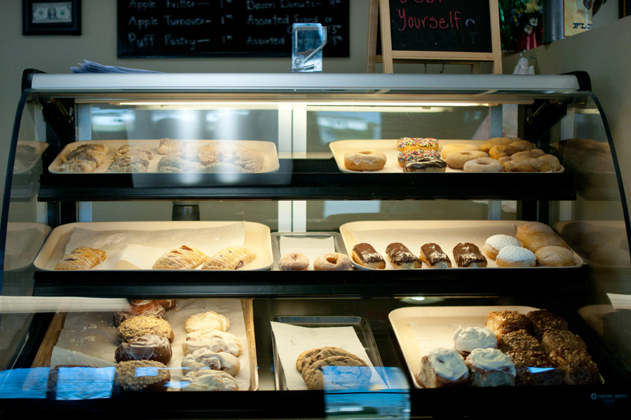 Cookies, cinnamon rolls and other baked goods line display window shelves inside Flour Haven. Photo: Emma Klak