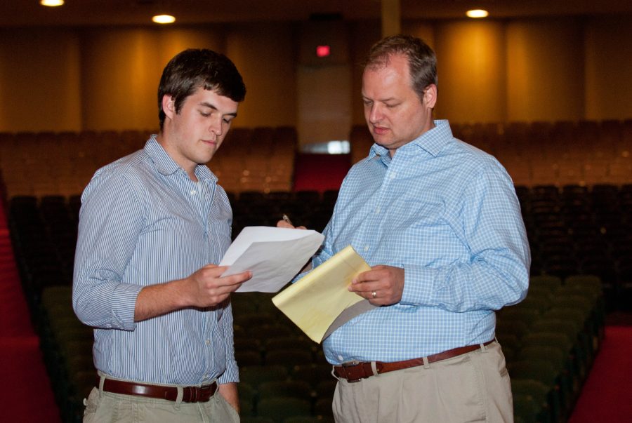 Junior Ben Nicholas and Mr. Christopher Zydowicz compare scripts to prepare for Friday’s Vespers. Photo: Molly Waits