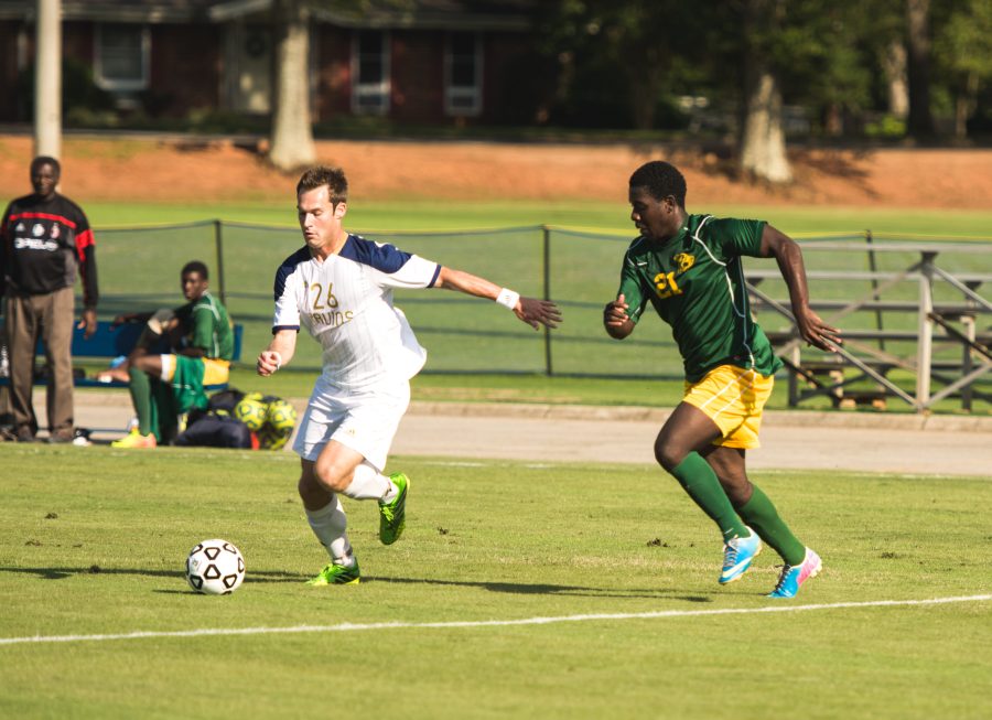 Bruins forward Travis Woodham leads the ball away from a Concordia College defender.  Photo: Dave Saunders 