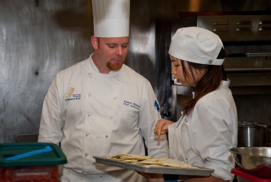 Culinary arts faculty member Robert Hansen and sophomore Urim Lee discuss plating options.
 Photo: Molly Waits 
