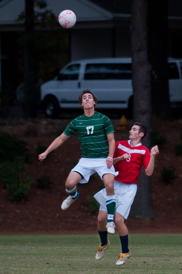 Alpha’s Tommy Colavito  heads the ball away from Sigma’s Tim Sampson.
 Photo: Molly Waits 