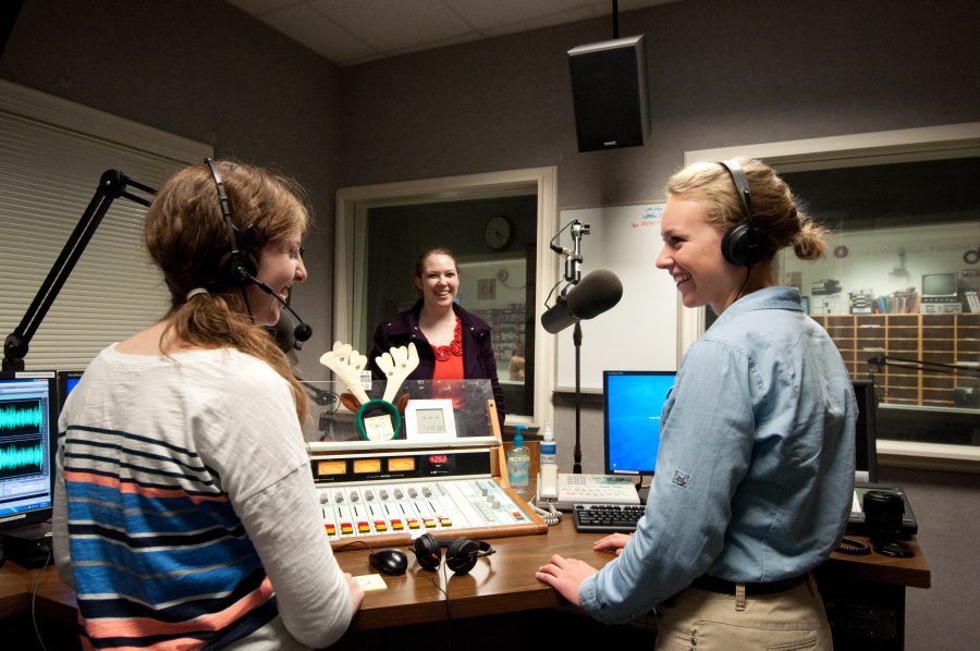 Kaitlyn Kinney, Catherine McCrary and Emilee Nelson practice in the studio for WBJU’s Christmas broadcast.  Photo: Amanda Ross 