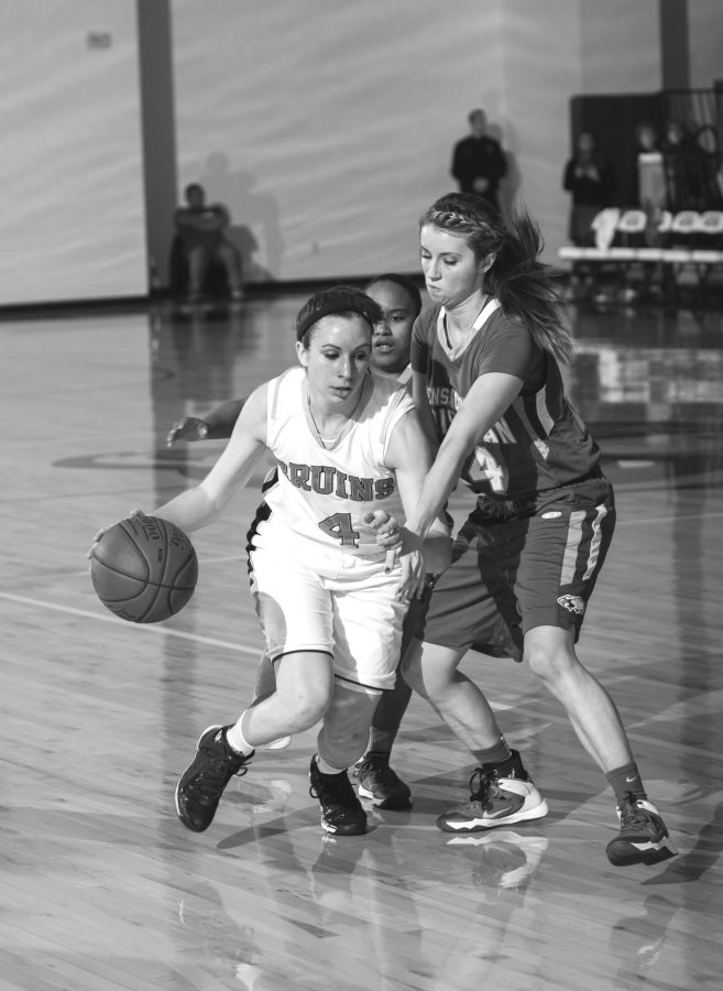 Sophomore guard Abby Conover attempts to drive past an Eagle defender.    Photo: Dave Saunders