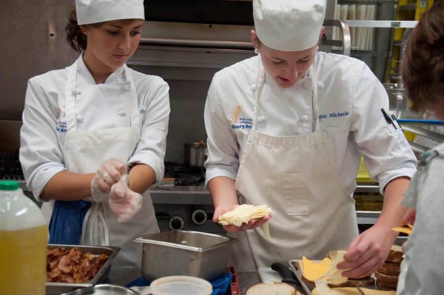 Abby Hughes and Robin Michaels practice their food preparation skills for the upcoming Bistro. Photo: Ethan Rogers
