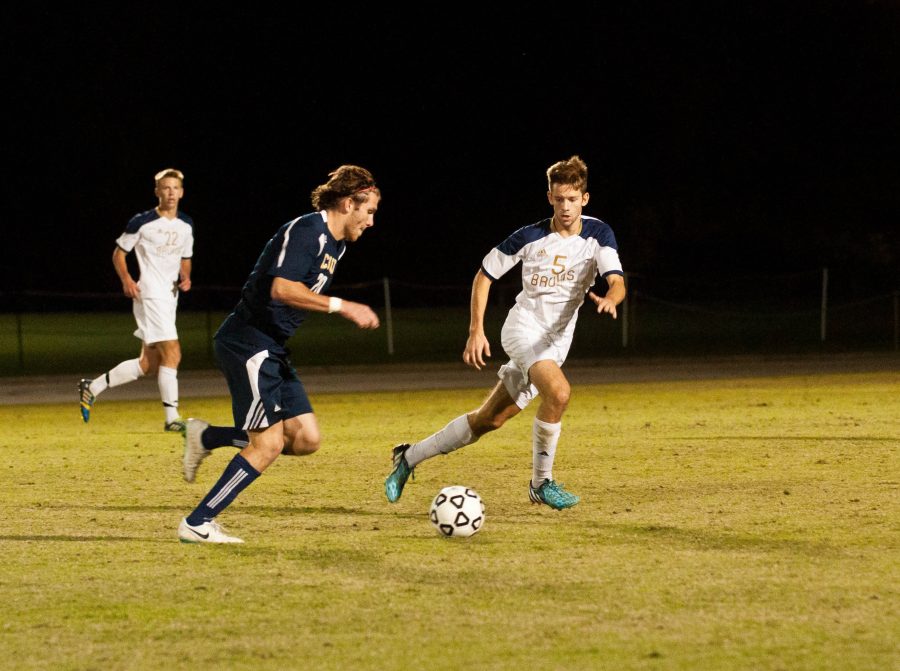Andrew Moisant defends against a CIU offensive player. Photo: Holly Diller