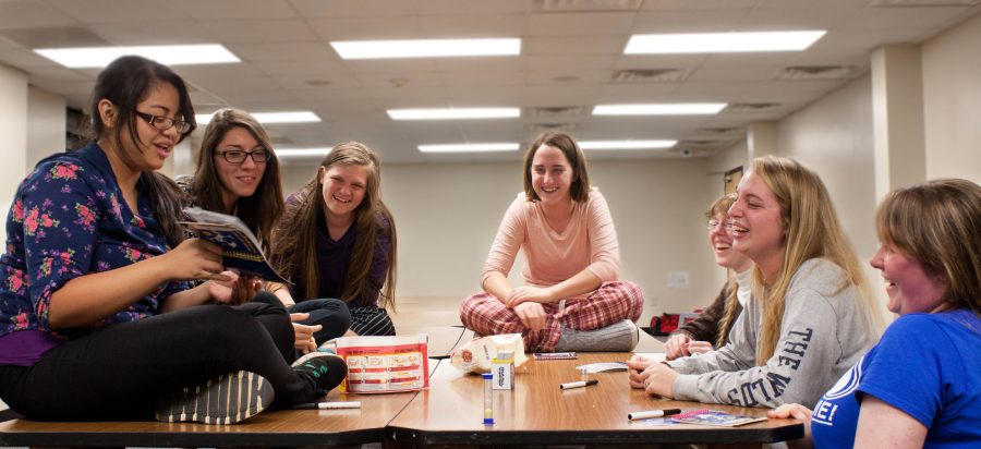 Lizzy Alagaban leads a lively game of Telestrations with her discipleship group in the Gaston study lounge. Photo: Holly Diller