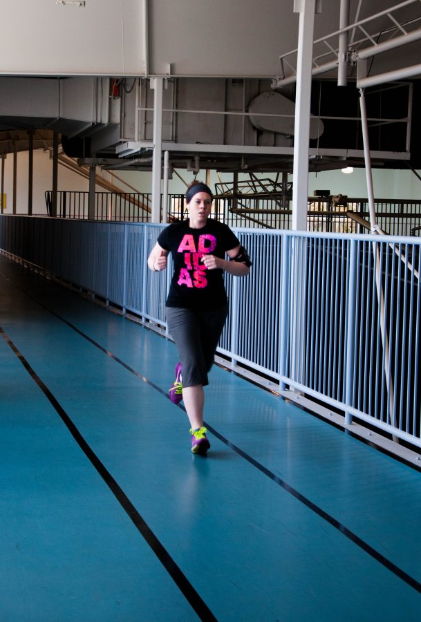 Deleah Foster takes time to run laps in the Davis Field House. Photo: Holly Diller