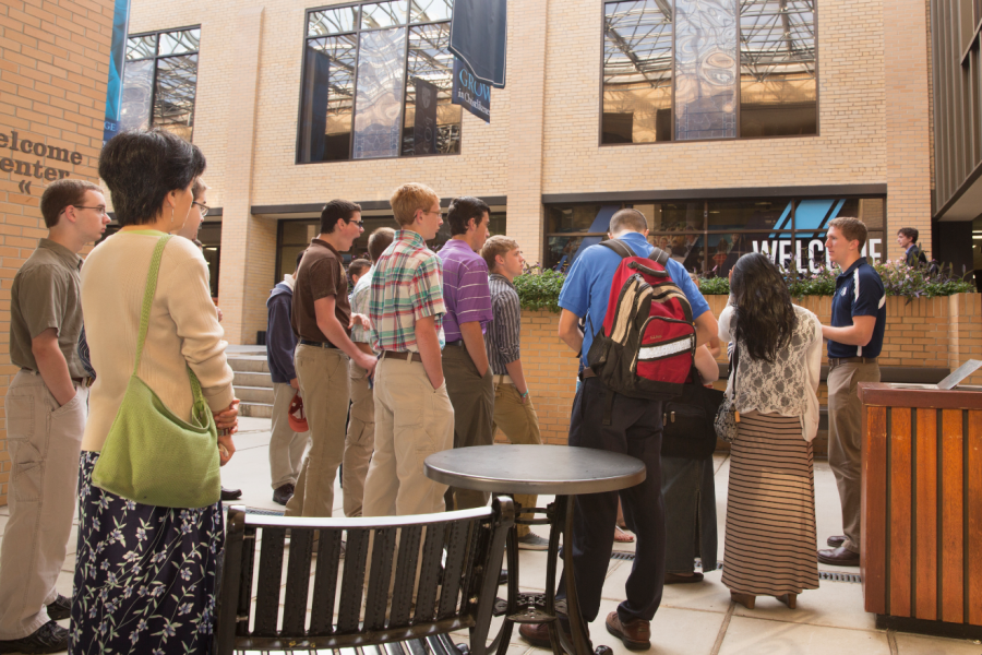 Prospective students stand outside the Welcome Center during  a campus tour on a Preview Day in 2013. Photo: Photo Services