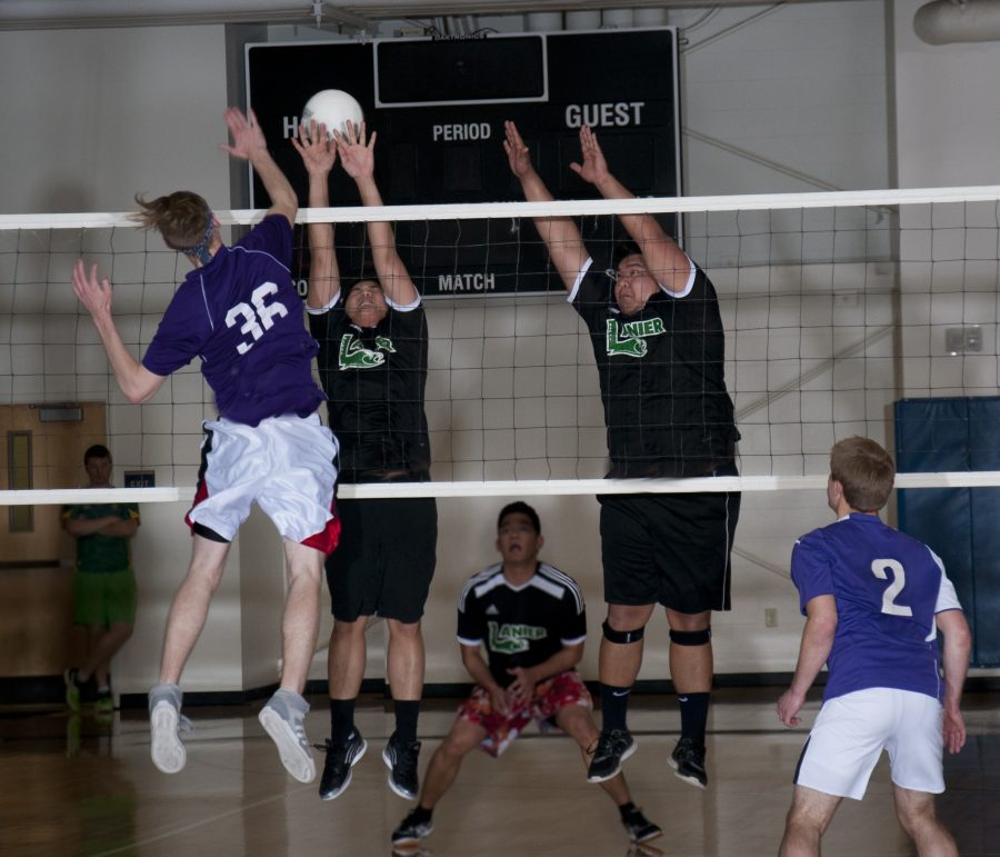 Lanier players jump for a volley from Pi Gamma.  Photo: Holly Diller