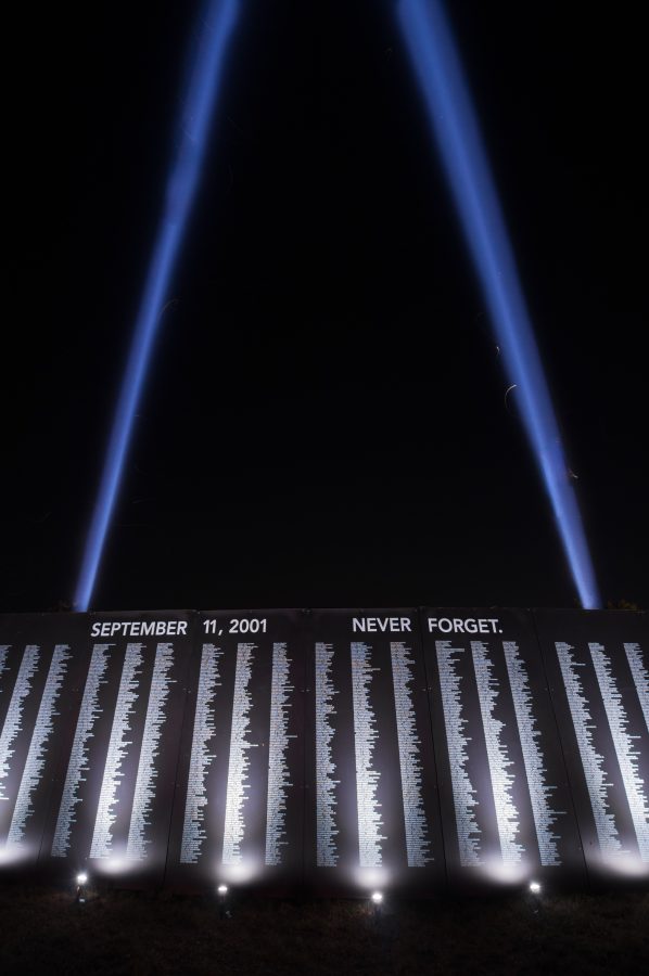 2 Beacons light up to commemorate the Twin Towers, next to the sign displaying the names of the fallen.