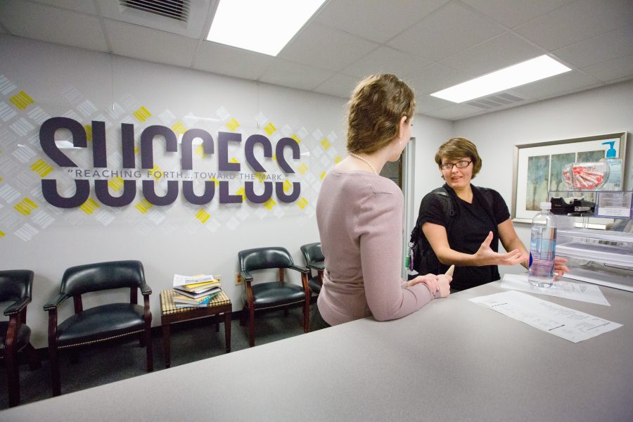 Student talks with Graduate Assistant in Academic Success Center. Photo by Derek Eckenroth, 2014