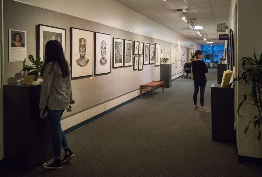 The Senior Studio Art Majors display their work in the Sargent Art Building hallway. Photo by Rebecca Snyder. 30.21