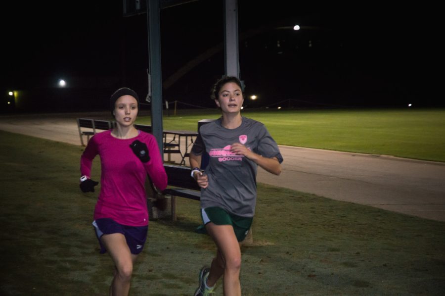 Two members of the ladies cross country team run during early morning training in Alumni Stadium BJU, Greenville, SC, October 17, 2017. (Ian Nichols)