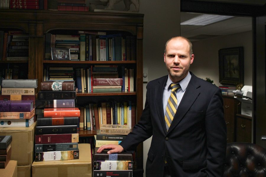 The Bibles intended for students in Crockett’s office outnumber the books in his personal library.    Photo: Daniel Quigley