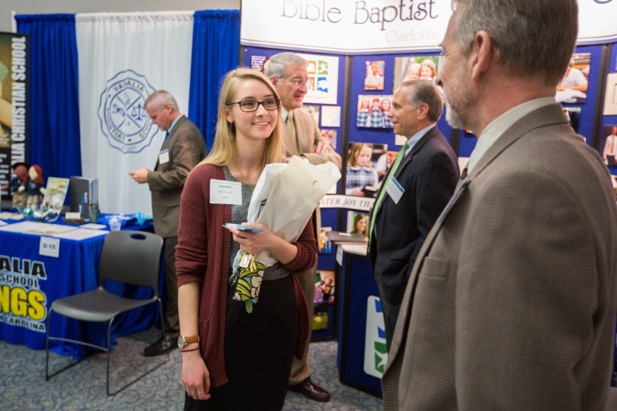 Alison Heape discovers opportunities while talking to school representatives at the Christian School Recruitment Conference and Career Fair.    Photo: BJU Market/ Derek Eckenroth