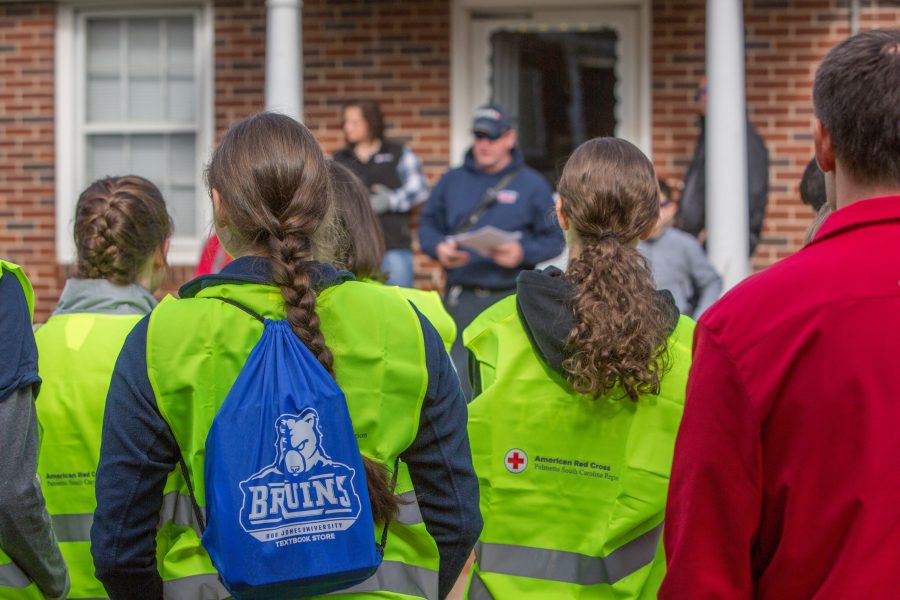 BJU students work with American Red Cross, Greenville Fire Department and Police to install smoke alarms in the community surrounding Poe Baptist Church, Greenville, SC, March 11, 2017. (Hal Cook)