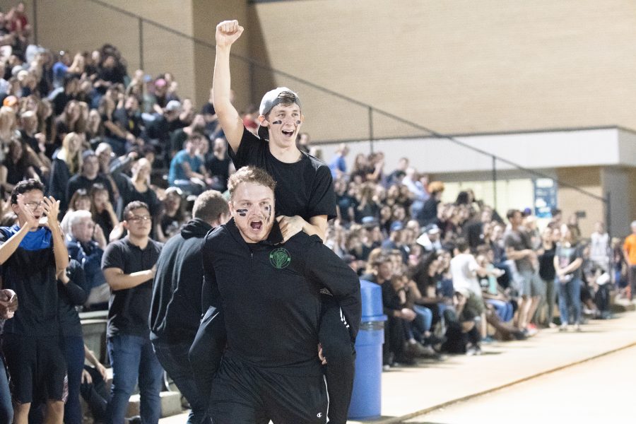 Derek Eilert and Max Burak lead students in cheers at an athletic event.  Photo: Abby Anglea