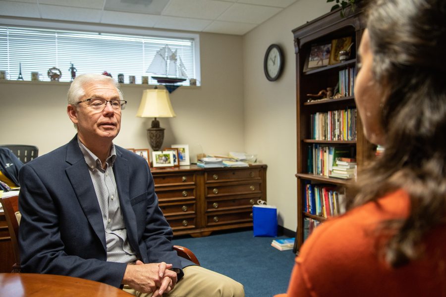 Dr. Brian Carruthers meets with an education student in his office.    Photo: Robby Jorgenson