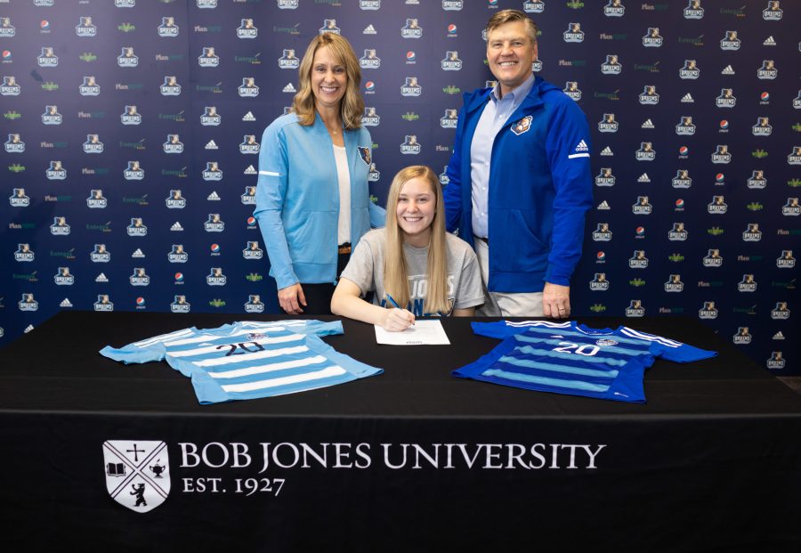 Caitlyn Benson, supported by her parents, signs with the Bruins womens soccer in 2019. Photo submitted