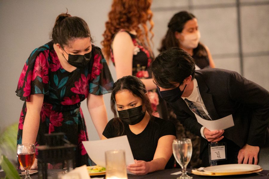 Participants in the Murder Mystery Dinner fundraiser study their notes from interactions to discover
which one of the characters, played by volunteers, is guilty. Photo: Taylor Caldwell