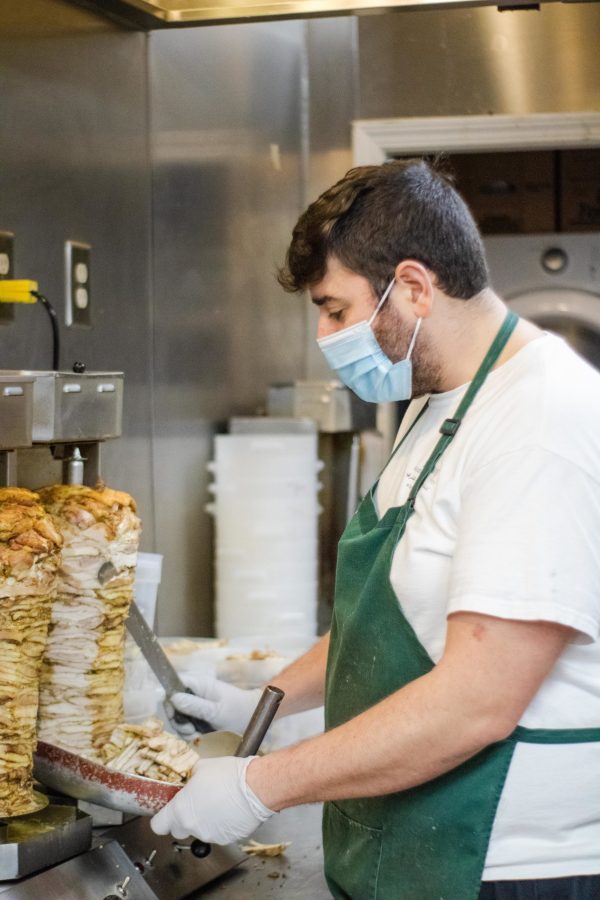 Hani Namouz prepares food for his customers. Photo: Nick Zukowski