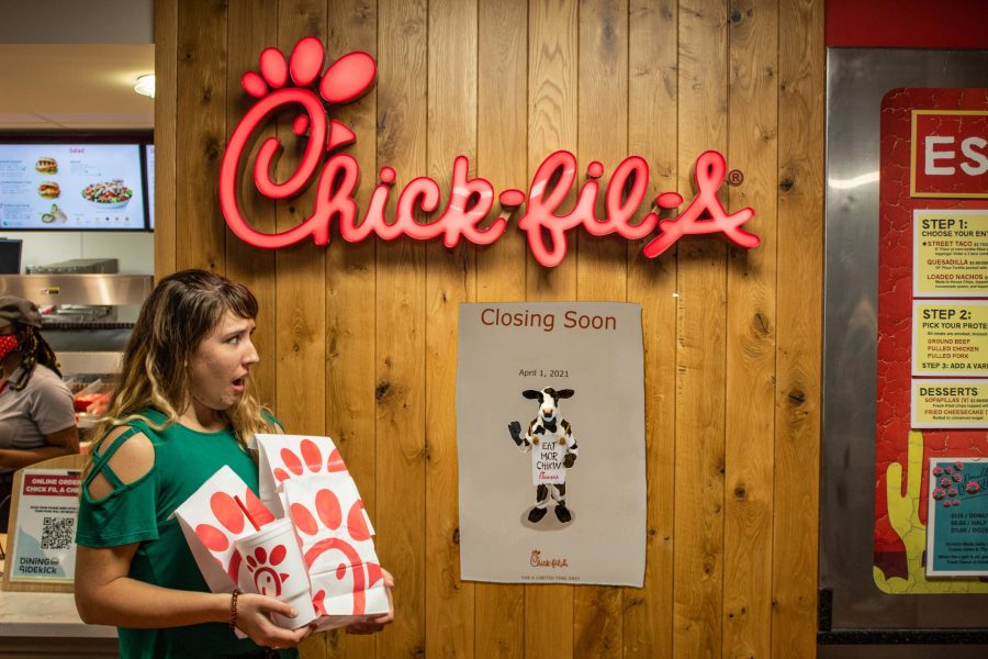 Senior Katelyn Lain stares in horror at the poster proclaiming Chick-fil-as imminent permanent, unchangeable, really happening closing. Photo: Robert Stuber and Andrew Pledger