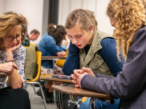 During the Jan. 19 Missions Advance meeting, Dr. Carol Loescher (left), missionary to Franch, prayed with students after presenting lessons she learned from working in medical missions. Photo: Nathaniel Hendry