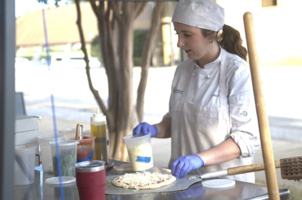 Culinary Arts students prepare a pizza for baking for a customer at The Bistro. Staff/Heather Battles 