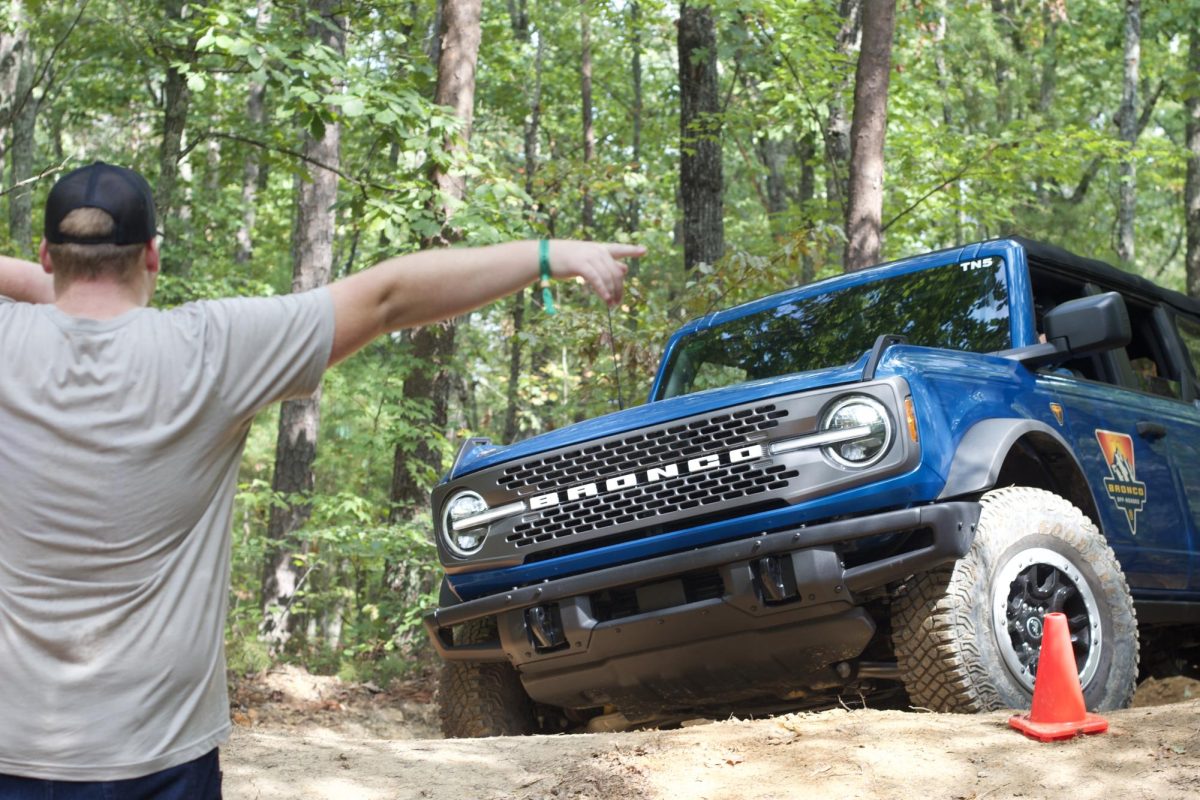 Zachariah Scott, a junior accounting major, guiding the blind driver through the obstacle course.