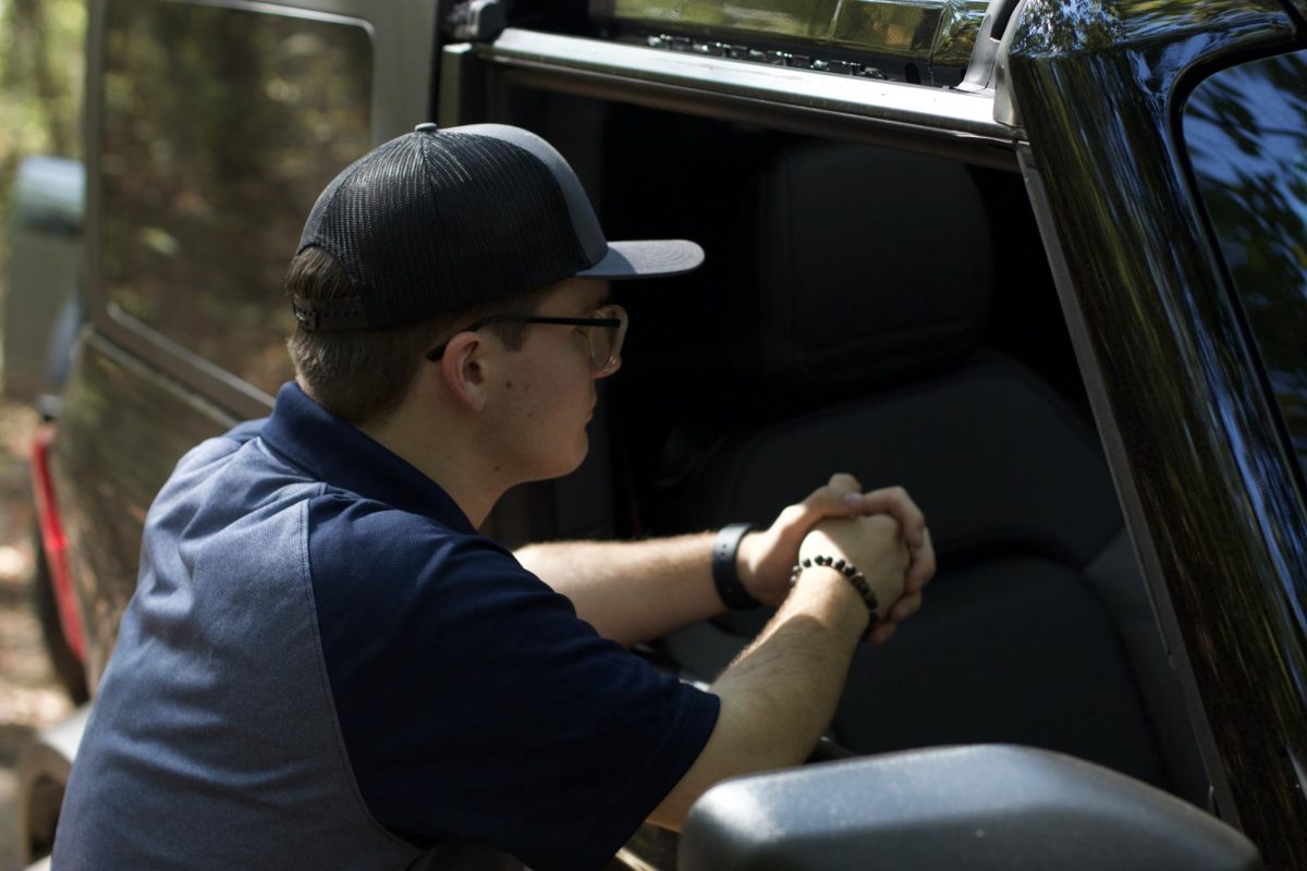 Adam Banks, a GA in the business department, waiting with the bronco.