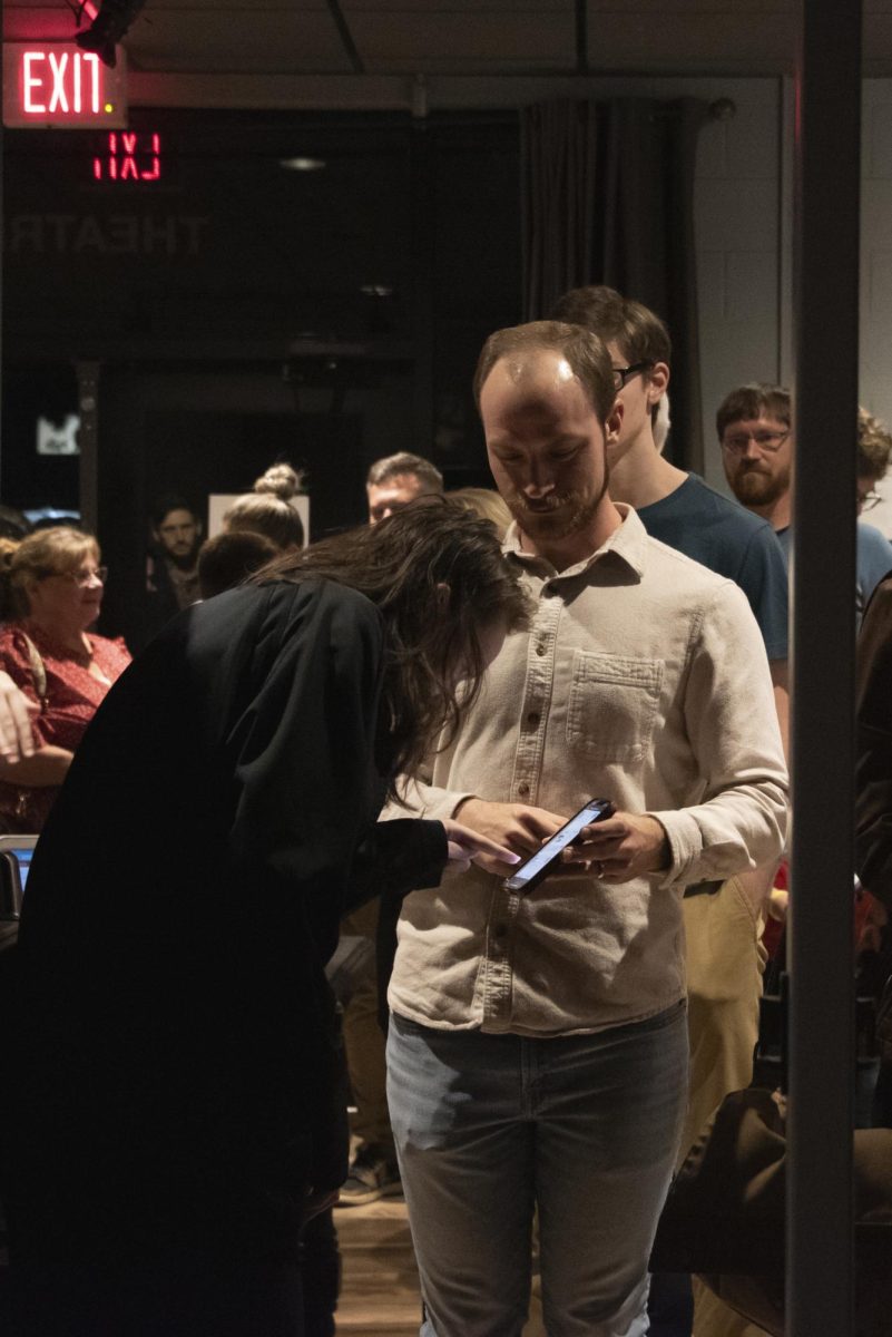 Audience members walk in to see Wait Until Dark directed by Taylor Stephens.