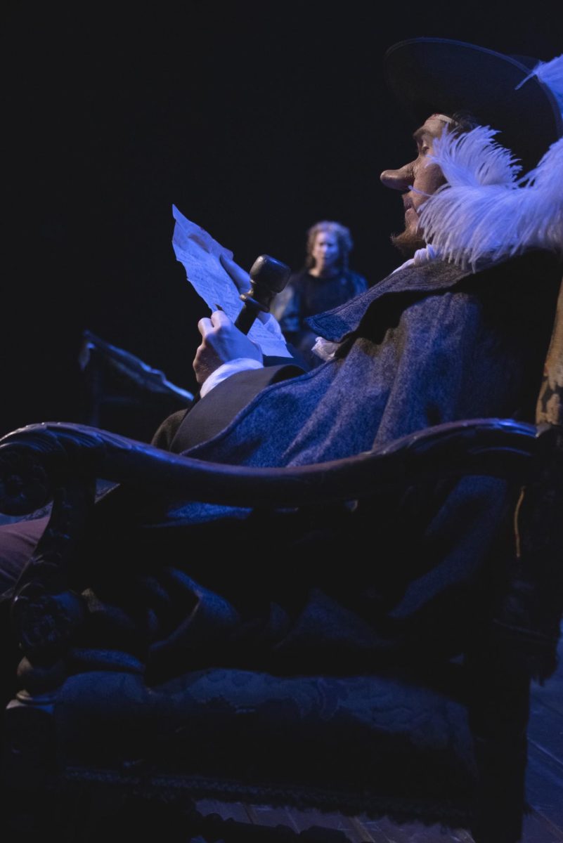 Cyrano de Bergerac (Issac Stephens) reads a letter out loud to Roxane (Arianna Jenks).