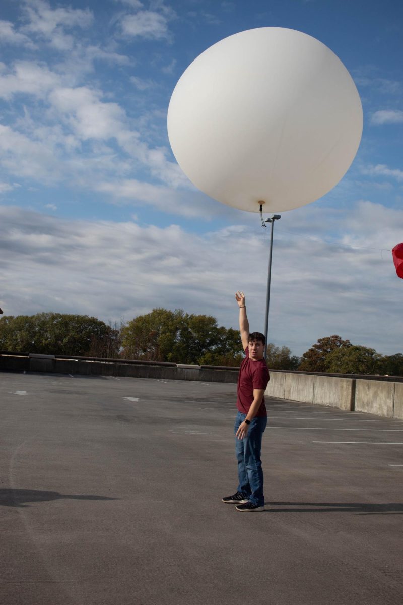 A student waits to release a weather balloon.