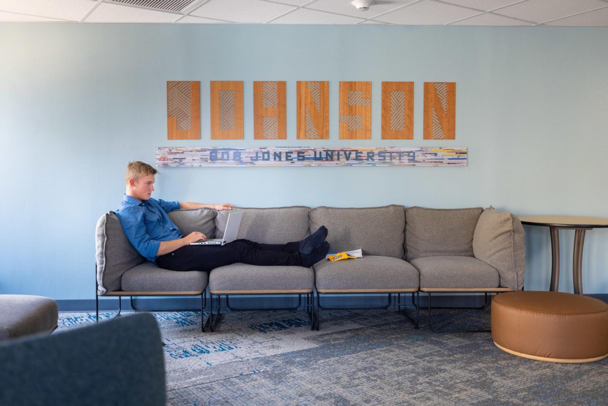 A student lounges on a couch in Johnson Residence Hall, which will no longer be reserved for first-year students. Photo provided by Derek Eckenroth