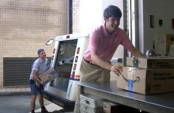 Collegian reporter (and part-time post office employee) Zachary Edmondson unloads packages at the post office location on the BJU campus. Photo provided. 