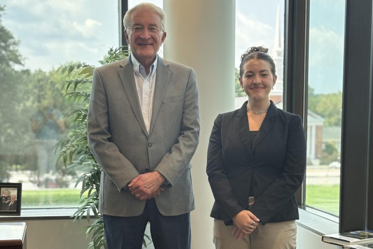 Dr. Bruce McAllister, left, with Olivia Adams, right, the Collegian's editor-in-chief. 