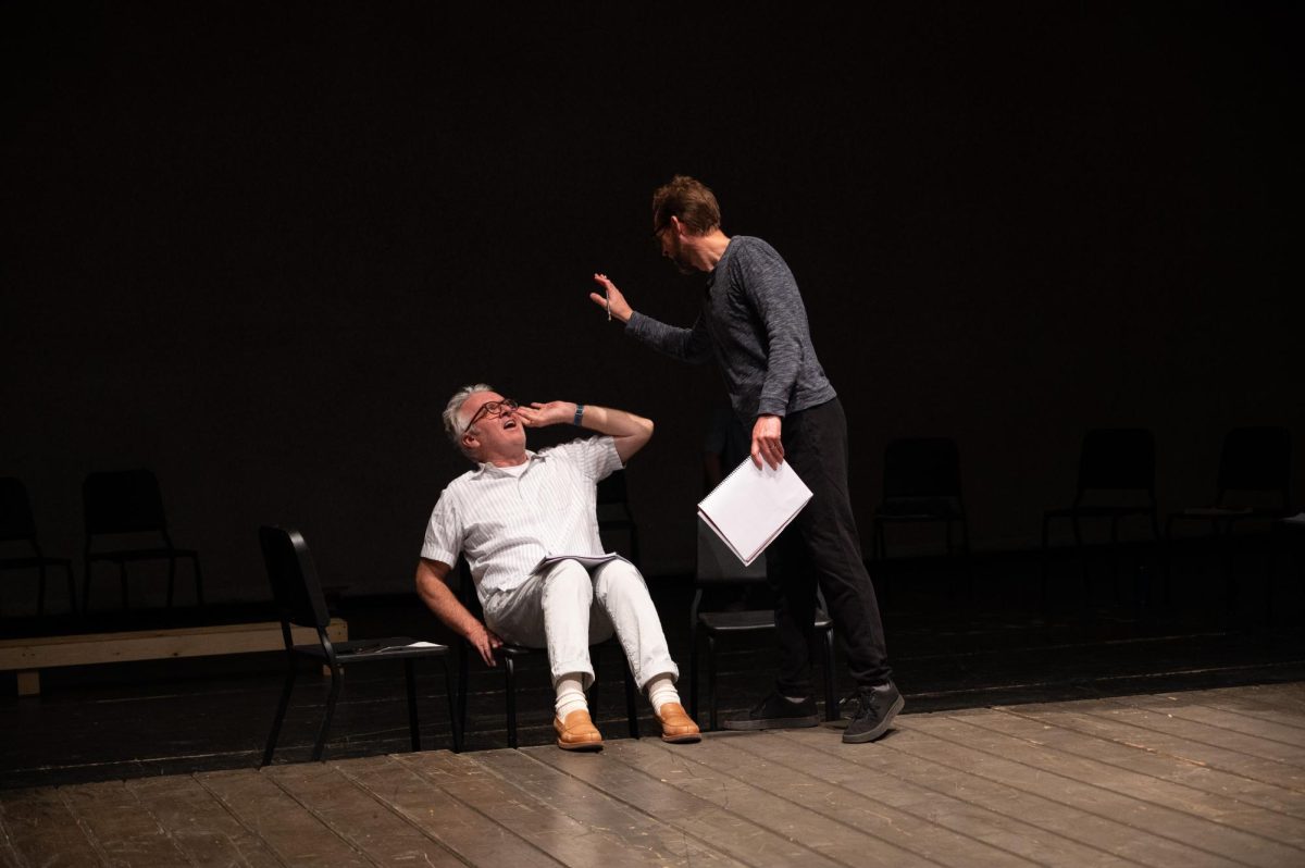 Dr. Schwingle and Dr. Stegall talking with each other while going through the King Lear script.