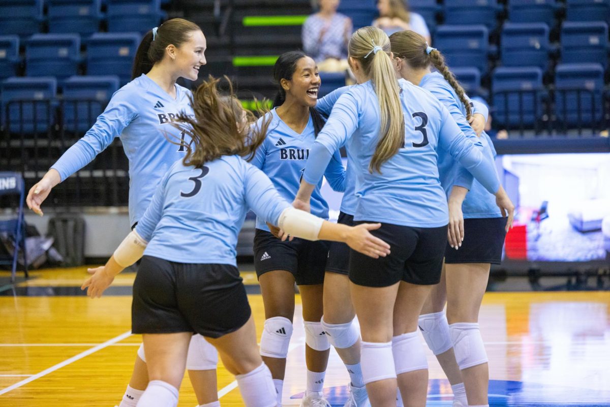 The team celebrates in a huddle.