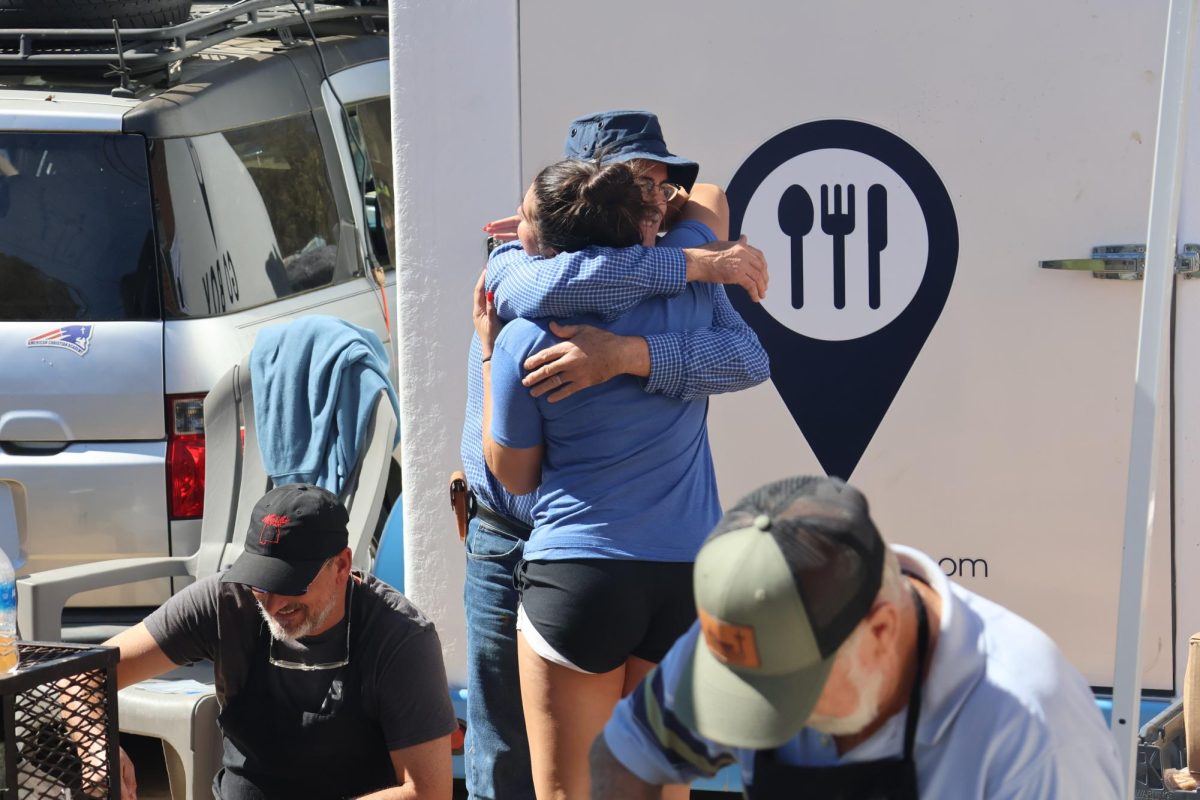A refugee hugs a volunteer worker.