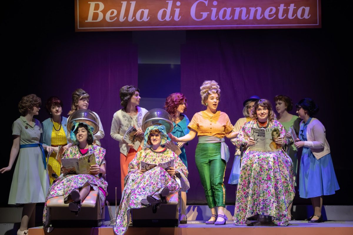 Julia Probus, a senior Music major, leading the beauty salon scene in Elixir of Love.