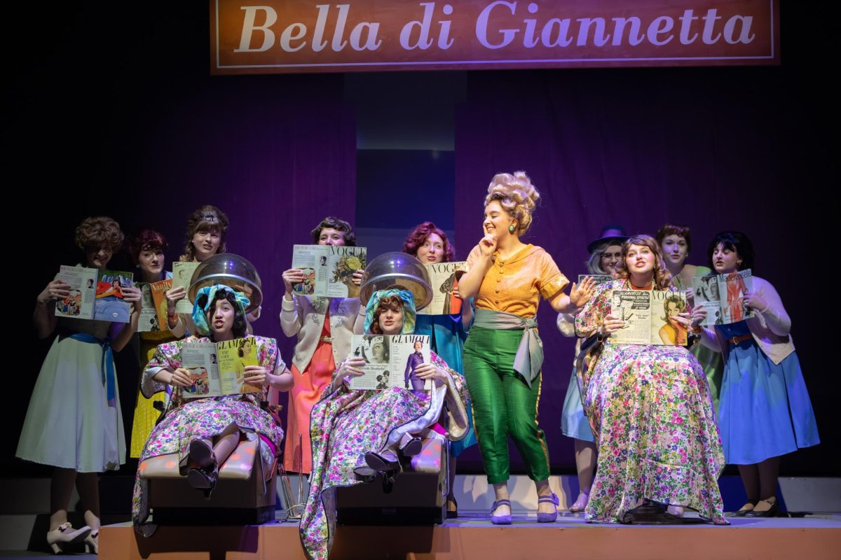Julia Probus, a senior Music major, leading the beauty salon scene in Elixir of Love.