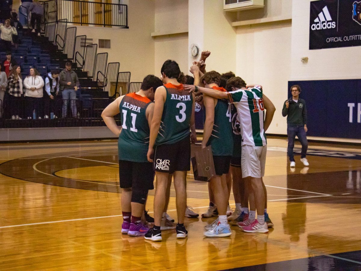 The Alpha Theta Pi Razorbacks huddle on the court after their championship victory on February 27, 2026.