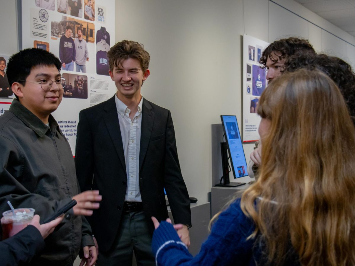 Andrew Carver with guests at his portfolio presentation