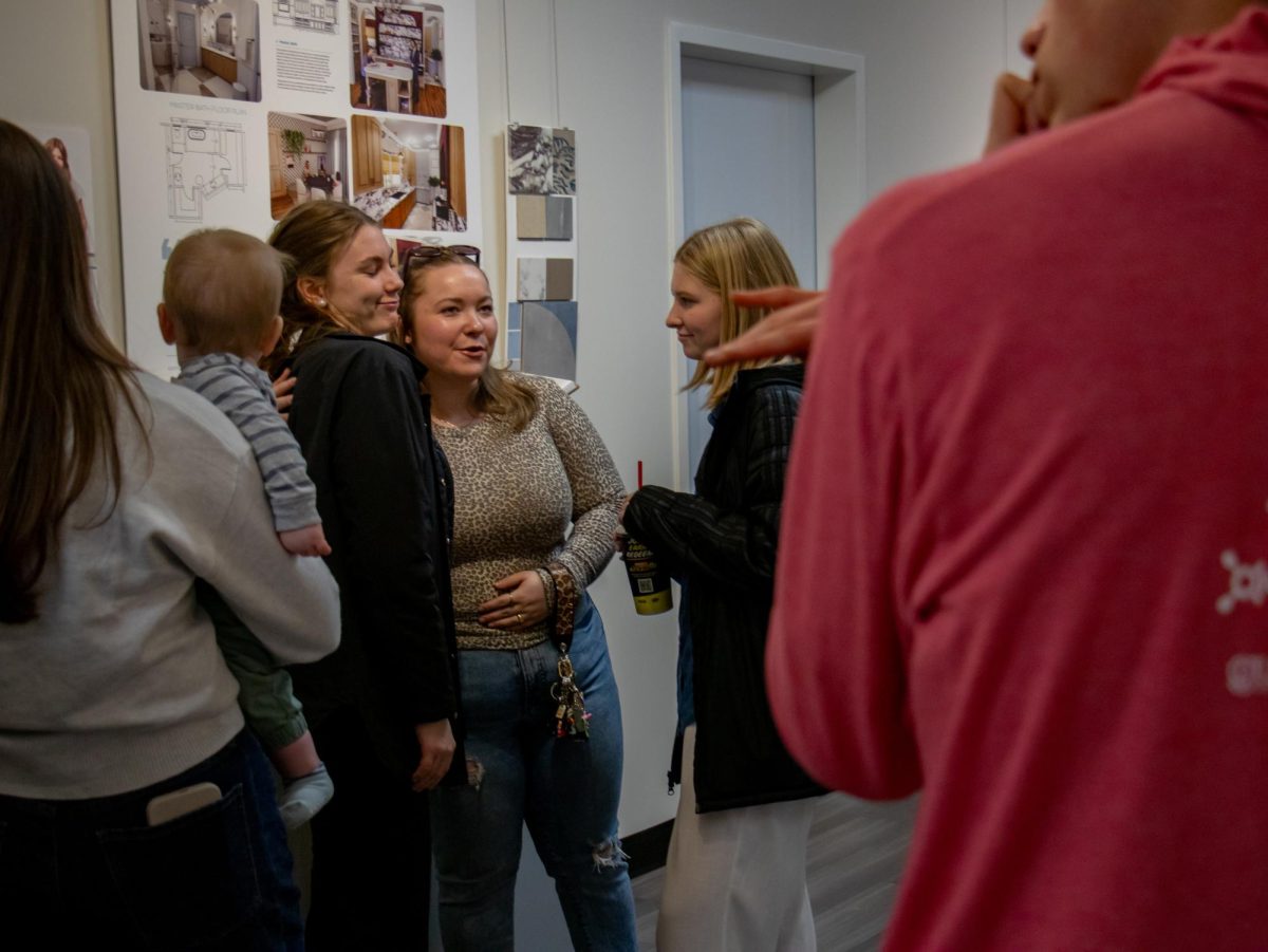 Kaylee Poore greeting guests at her portfolio presentation