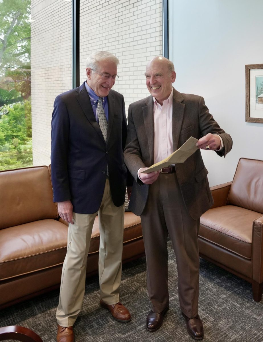 Dr. Bruce McAllister, BJU president (left), is presented with the original Bob Jones College charter by Dr. John Matsko, the university's historical consultant, on April 6, 2026. 