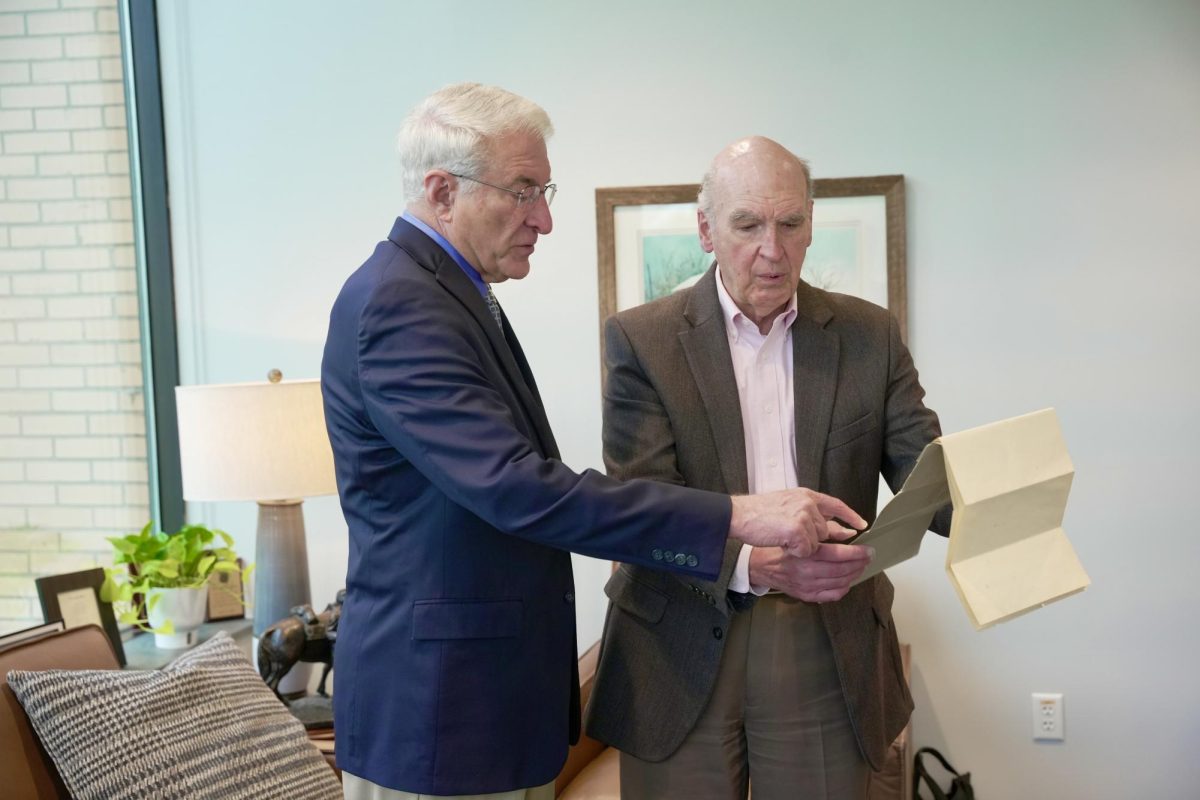 Dr. Bruce McAllister, BJU president (left), is presented with the original Bob Jones College charter by Dr. John Matsko, the university's historical consultant, on April 6, 2026. 